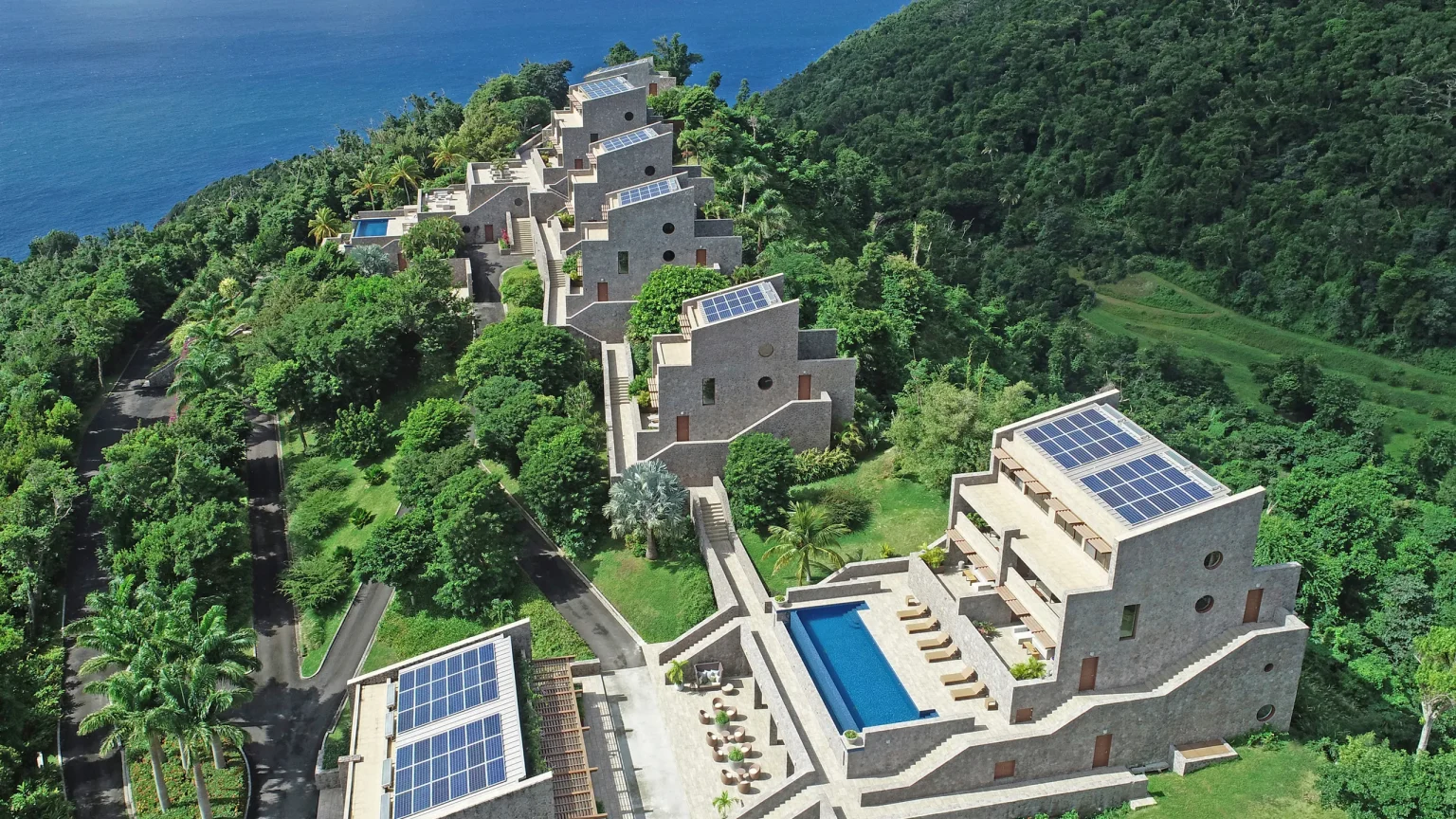 Aerial view of Coulibri Ridge, a luxurious eco-resort nestled in the lush mountains of Dominica with panoramic ocean views and sustainable architecture powered by solar energy.